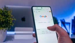 An SEO consultant performing a Google search on his phone.