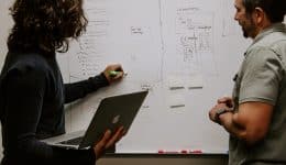 UX Strategy Consultants planing a strategy on a whiteboard
